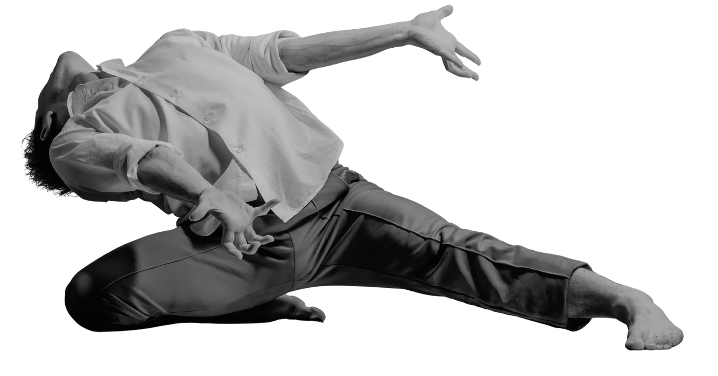 A contemporary dancer in a dramatic floor extension, backlit on a soft glow