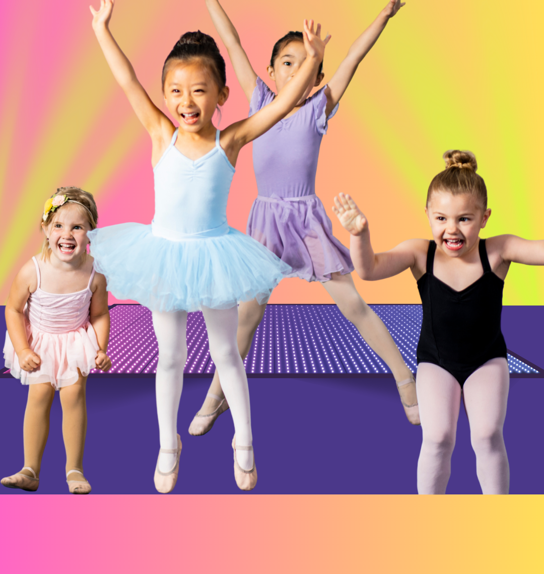 Four young dancers in tutus leaping with joy